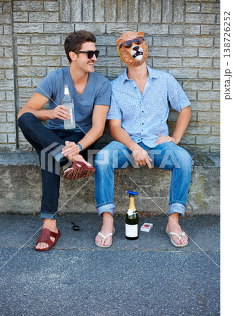 Friends, alcohol and fun with mask at party outdoor, laughing and together. Smile, men in sunglasses and beer for celebration at street by wall, drink champagne and drunk with animal disguise in city Friends, alcohol and fun with mask at party outdoor, laughing and together. Smile, men in sunglasses and beer for celebration at street by wall, drink champagne and drunk with animal disguise in city 138726252