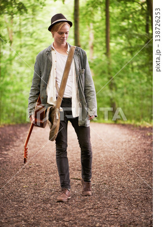 Thinking, forest and man with guitar, music and walk in nature for talent, journey or inspiration. Artist, musician or guitarist with creative insight, trees and travel adventure trekking in woods Thinking, forest and man with guitar, music and walk in nature for talent, journey or inspiration. Artist, musician or guitarist with creative insight, trees and travel adventure trekking in woods 138726253