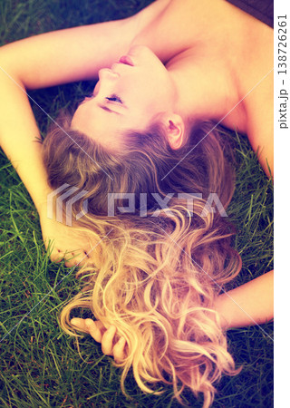 Thinking, hair and a woman on the grass from above to relax in nature during summer for freedom. Idea, beauty and a girl in the park, lying on a field outdoor to rest on a green background alone 138726261