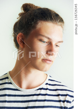 Young, man and thinking with face in studio for looking, idea or vision on white background in London. Male model, pose and hairstyle with bun, different and indie for clothes, fashion and trendy Young, man and thinking with face in studio for looking, idea or vision on white background in London. Male model, pose and hairstyle with bun, different and indie for clothes, fashion and trendy 138726345