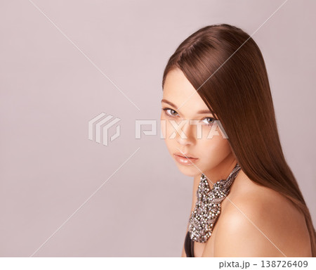 Cosmetics, portrait or woman with fashion, jewellery and hair care in studio for wellness and beauty. Person, face and skincare with natural glow, keratin or treatment on brown background with mockup 138726409