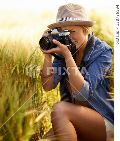 Woman, camera and photography with summer, vacation and holiday with wheat field and travel. Nature, photographer and outdoor with traveler blog and countryside with photo for adventure and journey 138726594
