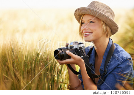 Field, smile and woman with a camera, photographer and sunshine with tourism, travelling and nature. Person, photography or girl with summer, thinking or countryside with picture, freedom or creative 138726595
