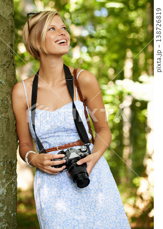 Happy, nature and photographer with woman in forest for relax, memory or travel photography. Summer, trees and adventure with female person with camera for vacation, holiday and environmental tourism 138726819