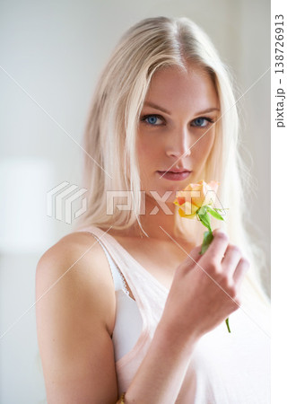 Portrait, woman and holding of flower in bedroom for romance with headshot in Norway. Female person, looking and hand with rose for love, trust or care in relationship for growth, bond and partner Portrait, woman and holding of flower in bedroom for romance with headshot in Norway. Female person, looking and hand with rose for love, trust or care in relationship for growth, bond and partner 138726913