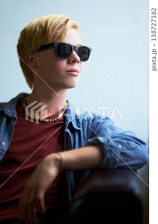 Fashion, sunglasses and teenager relax in home, living room or thinking of summer or vacation. Cool, guy and college student on sofa in lounge or apartment with ideas for style on weekend or holiday Fashion, sunglasses and teenager relax in home, living room or thinking of summer or vacation. Cool, guy and college student on sofa in lounge or apartment with ideas for style on weekend or holiday 138727182