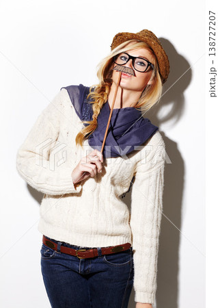 Portrait, woman and holding a moustache for a party, photo or comic on a white background for fun. Funny, goofy and a girl with a prop at an event for crazy, comedy and celebration for a picture 138727207