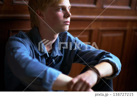 Thinking, depression and an unhappy boy student at school as an outcast feeling lonely in a classroom. Education, scholarship and a sad young child in a class looking bored while alone on campus 138727215