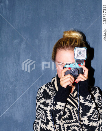 Woman, photography and retro camera on wall background for aesthetic, shooting or creative image. Photographer, person or girl and face with vintage, picture and serious for memory on mock up space Woman, photography and retro camera on wall background for aesthetic, shooting or creative image. Photographer, person or girl and face with vintage, picture and serious for memory on mock up space 138727313