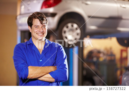 Happy, portrait and a mechanic with arms crossed in a workshop for pride in a car. Smile, working and a man in a garage for work, maintenance or building a vehicle for transportation or inspection 138727322