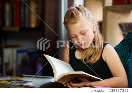 Girl, child and library for reading book, education and learning of language, literature and fiction story on sofa. Kid relax in bookstore with novel for creative development, knowledge and school Girl, child and library for reading book, education and learning of language, literature and fiction story on sofa. Kid relax in bookstore with novel for creative development, knowledge and school 138727391