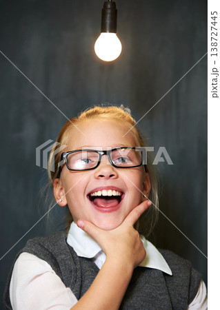 Student portrait, girl and lightbulb for solution, learning and wow, surprise or excited for future, ideas and knowledge in school. Child or kid with light bulb, emoji and black chalkboard for vision 138727445