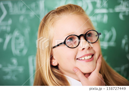 Thinking, idea and child student with glasses by board for planning, decision or brainstorming in classroom. Education, learning and girl kid with choice, vision or solution face expression in school Thinking, idea and child student with glasses by board for planning, decision or brainstorming in classroom. Education, learning and girl kid with choice, vision or solution face expression in school 138727449