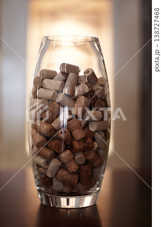 Winery, glass and jar with a group of cork plugs on a wooden table closeup for decoration or preservation. Background, texture and interior design with stopper seals in a vase for sustainability Winery, glass and jar with a group of cork plugs on a wooden table closeup for decoration or preservation. Background, texture and interior design with stopper seals in a vase for sustainability 138727468