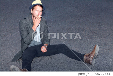 Portrait, outdoor and man smoking, hipster on the ground and relax with fashion, casual and stylish. Person, outdoor and guy with cigarette, tobacco and smoke with casual, trendy and outfit clothes Portrait, outdoor and man smoking, hipster on the ground and relax with fashion, casual and stylish. Person, outdoor and guy with cigarette, tobacco and smoke with casual, trendy and outfit clothes 138727533
