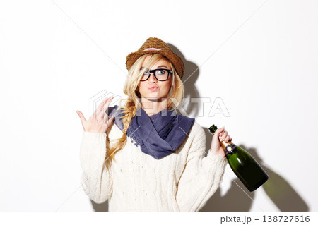 Woman, blonde and hat with champagne of nerd, geek or hipster thinking against a studio background. Attractive female person with glasses, nerdy or fashion style gesture and holding bottle of alcohol Woman, blonde and hat with champagne of nerd, geek or hipster thinking against a studio background. Attractive female person with glasses, nerdy or fashion style gesture and holding bottle of alcohol 138727616