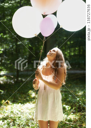 Woman, holding balloons and peace in nature, playful and outdoors in forest, party decor and celebrate for freedom. Female person, sunshine and birthday in park, milestone and achievement for growth 138727636