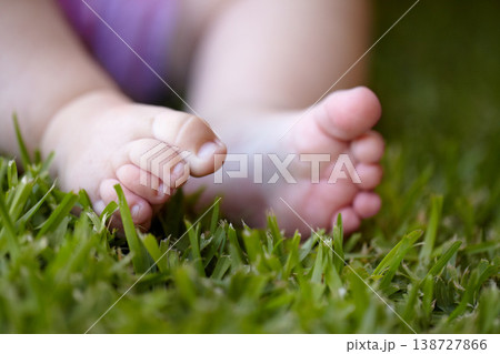 Feet, closeup and baby outdoor on grass, lawn and newborn toes on field in nature. Child, development or foot touching green, plants and close up of kid legs in garden with sensory experience Feet, closeup and baby outdoor on grass, lawn and newborn toes on field in nature. Child, development or foot touching green, plants and close up of kid legs in garden with sensory experience 138727866