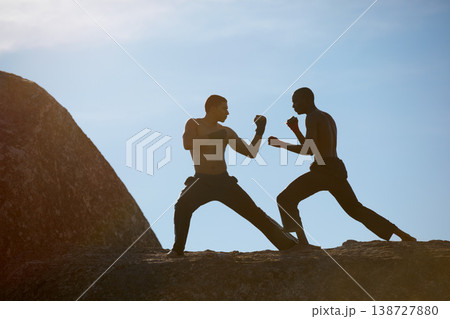 Mountain, fitness and karate men training in nature for body, speed or sparring technique on blue sky background. Martial arts, taekwondo or MMA friends outdoor for morning cardio, exercise or sports 138727880