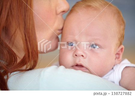Kiss, baby and portrait of newborn with mother in home bonding together with affection. Calm, face and mom carrying infant child in arms to relax in house with love, care and support with mommy 138727882