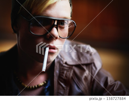 Portrait, addiction and a boy smoking a cigarette closeup for nicotine or tobacco dependency in sunglasses. Face, smoke and bad habit with a young person inhaling an addictive substance for cancer Portrait, addiction and a boy smoking a cigarette closeup for nicotine or tobacco dependency in sunglasses. Face, smoke and bad habit with a young person inhaling an addictive substance for cancer 138727884