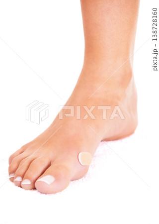 Closeup of injury, foot and plaster, skin and person has wound with health and medical aid on white background. Healthcare, bandage on blister and wellness with medicine, help and accident in studio Closeup of injury, foot and plaster, skin and person has wound with health and medical aid on white background. Healthcare, bandage on blister and wellness with medicine, help and accident in studio 138728160