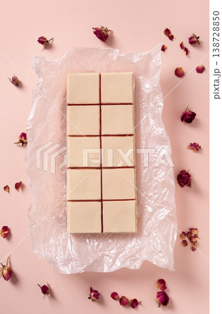 Top view pastel dessert squares with rose petals minimal flat lay composition 138728850