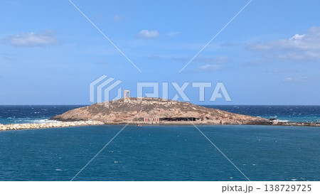 View of a small island with one of the Greek ruins of the Temple of Apollo seen from the ferry View of a small island with one of the Greek ruins of the Temple of Apollo seen from the ferry 138729725