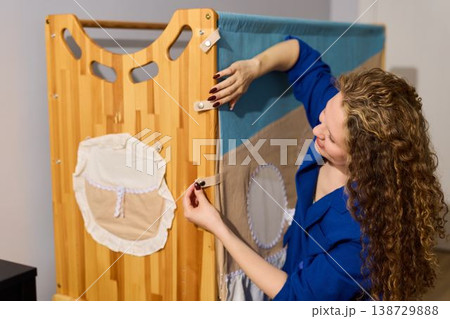 Caucasian woman styling nursery organizer for photoshoot Caucasian woman styling nursery organizer for photoshoot 138729888