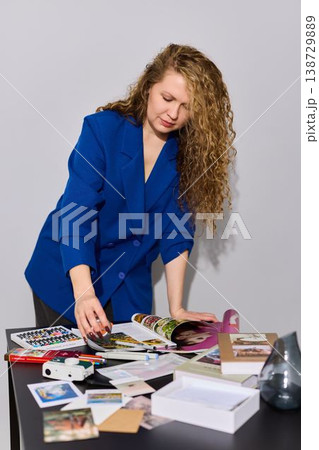 Individual meticulously arranging promotional content and invitations 138729889