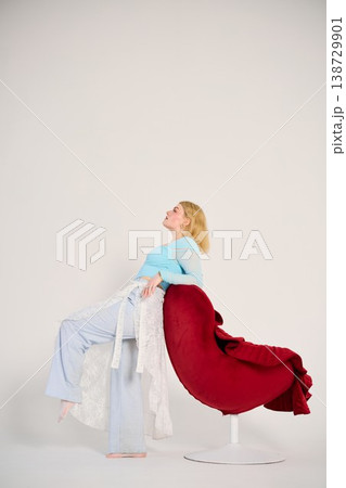 Tranquil woman seated with gentle illumination highlighting details Tranquil woman seated with gentle illumination highlighting details 138729901