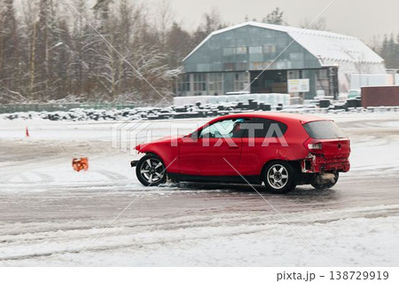 Stunt driver performs daring maneuver on snowy testing surface 138729919