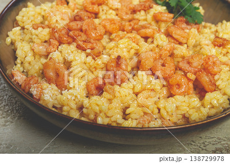 risotto with shrimp, in a bowl, on a textured surface, with a side dish of fresh coriander, homemade, no people, risotto with shrimp, in a bowl, on a textured surface, with a side dish of fresh coriander, homemade, no people, 138729978