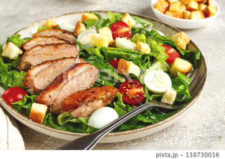 Caesar salad, with duck breast, on a light plate, on a light background, homemade, no people, Caesar salad, with duck breast, on a light plate, on a light background, homemade, no people, 138730016
