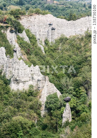 White erosion pinnacles and capped earth towers in Pyramids of Zone reserve near Lake Iseo Italy White erosion pinnacles and capped earth towers in Pyramids of Zone reserve near Lake Iseo Italy 138730100