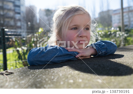 Close up portrait of a lovely 4 year old girl walking outdoors 138730191