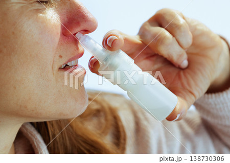 Profile of Woman Using Nasal Spray for Sinusitis 138730306