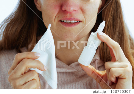 Woman with Tissue and Nasal Spray for Cold Relief 138730307