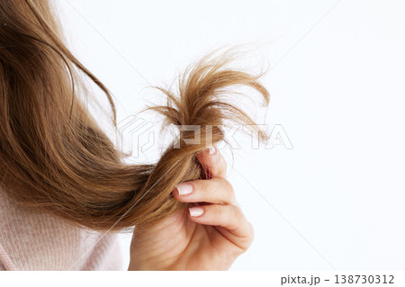 Close-Up of Dry and Frizzy Light Brown Hair Section Close-Up of Dry and Frizzy Light Brown Hair Section 138730312