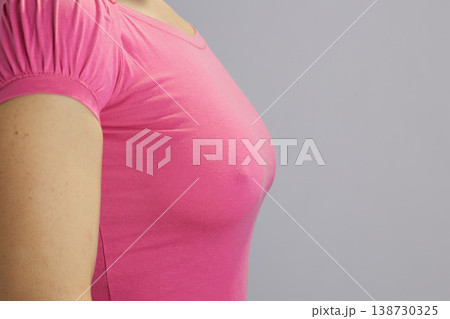 Side View of Woman in Pink T-shirt - Breast Awareness Concept Side View of Woman in Pink T-shirt - Breast Awareness Concept 138730325