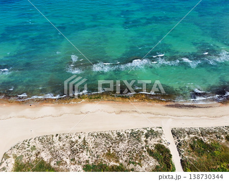 Aerial view of sandy beach and turquoise sea coastline 138730344
