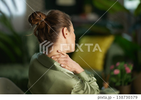 Back View of Woman Touching Sore Neck and Shoulders Back View of Woman Touching Sore Neck and Shoulders 138730379
