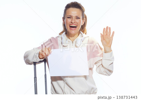 Cheerful Woman Waving with Blank Sign and Suitcase 138731443
