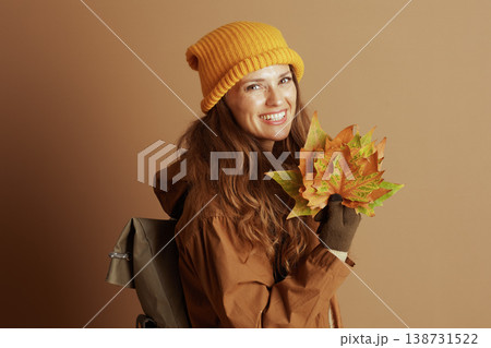 Happy Woman with Fall Foliage and Hiking Gear Happy Woman with Fall Foliage and Hiking Gear 138731522