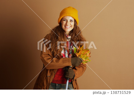 Happy Hiker with Autumn Leaves and Walking Stick 138731529