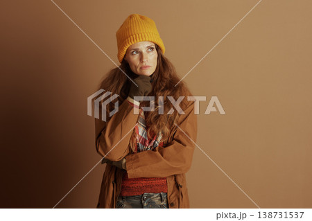 Woman Ponders, Hand on Chin in Winter Jacket Woman Ponders, Hand on Chin in Winter Jacket 138731537