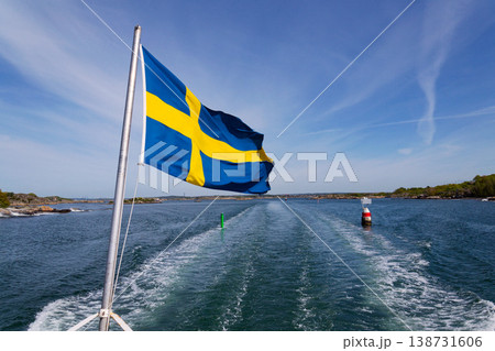 Swedish flag on ferry near bridge between Styrso and Donso islands of Gothenburg archipelago, Gothenburg Minucipality, Vastra Gotaland County, Sweden, sunny day Swedish flag on ferry near bridge between Styrso and Donso islands of Gothenburg archipelago, Gothenburg Minucipality, Vastra Gotaland County, Sweden, sunny day 138731606