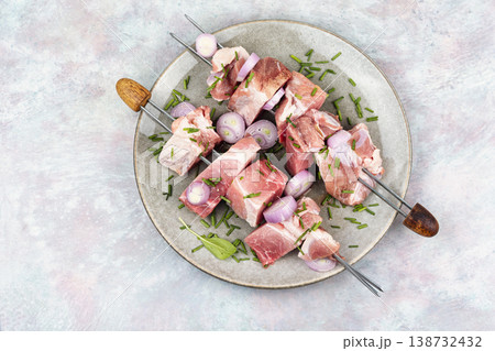 Raw Pork and Onion Skewers for Grilling on Plate 138732432