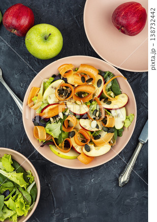 Healthy raw salad with apple slices carrot ribbons and seeds Healthy raw salad with apple slices carrot ribbons and seeds 138732442