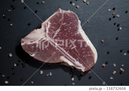 Raw T-Bone Steak on Granite Surface. Fresh Uncooked T-Bone Steak on Stone Background. Raw T-Bone Steak on Granite Surface. Fresh Uncooked T-Bone Steak on Stone Background. 138732608